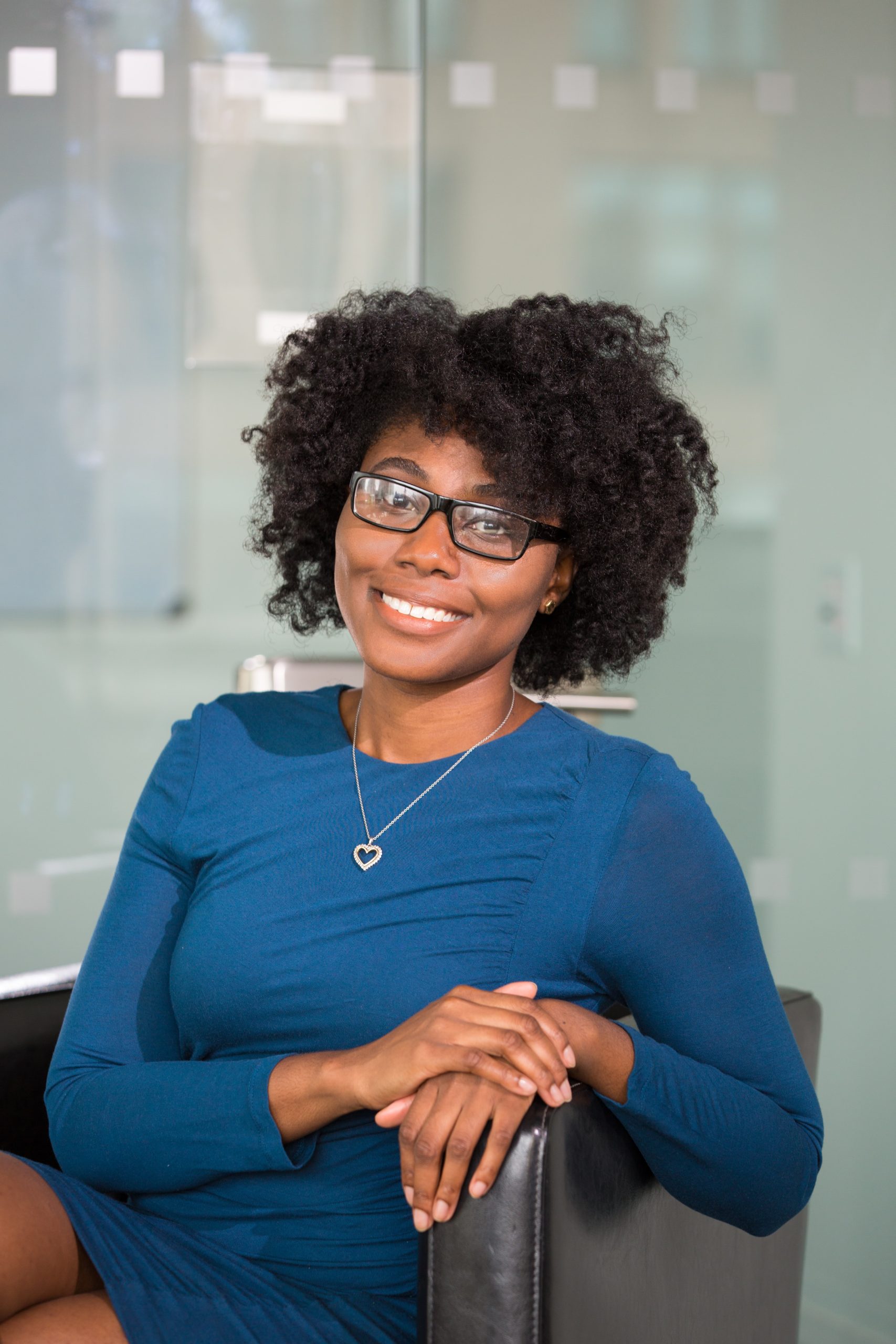 smiling women seated in office chair